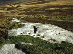 Landscape view of carved white rock and moorland
