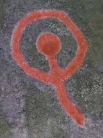 Carved motif in red ochre colour